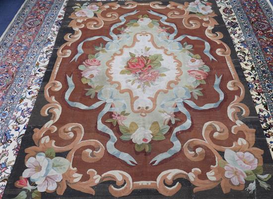 An Aubusson rug with central floral motif on a brown field 170 x 220cm